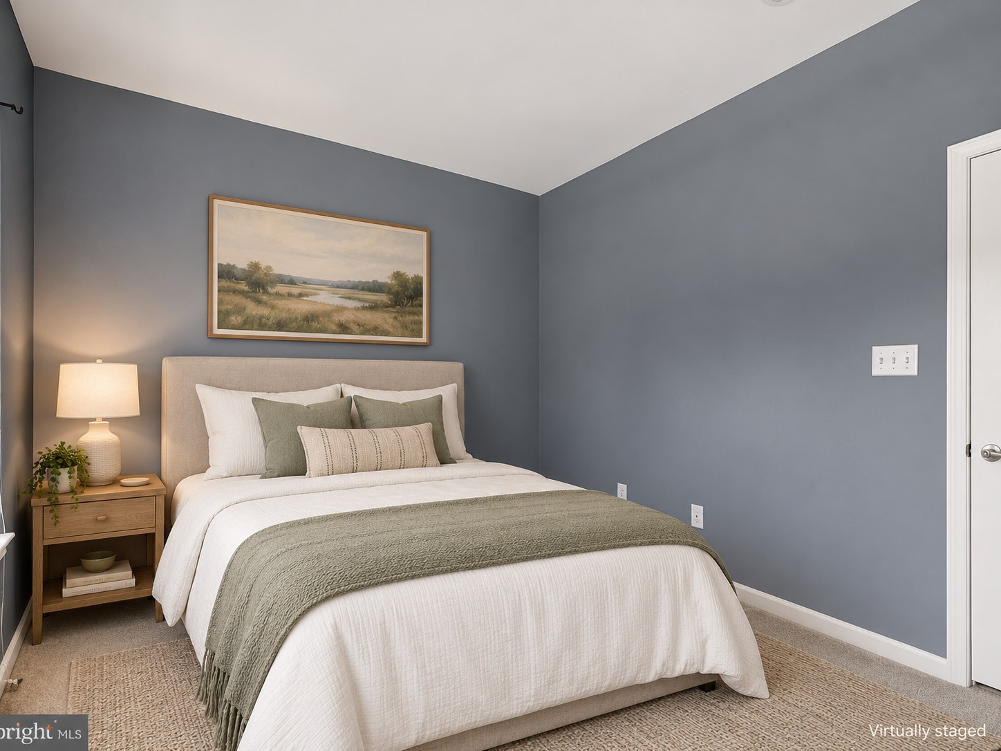 Bedroom with blue-gray walls and neutral bedding