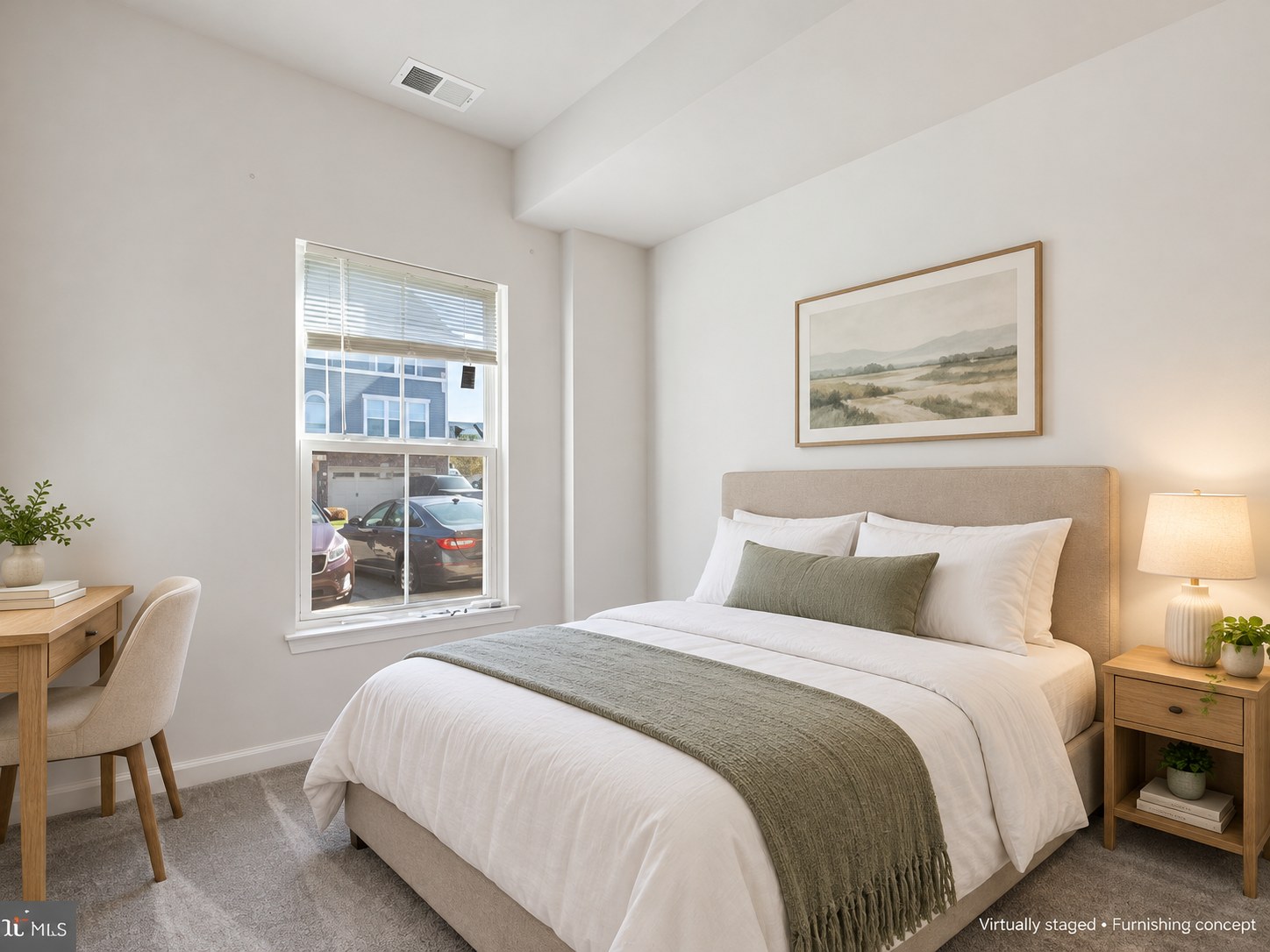 Bedroom with neutral bedding and natural light